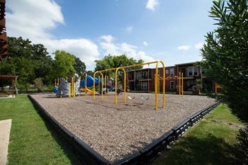 A playground with a swing set and a slide.